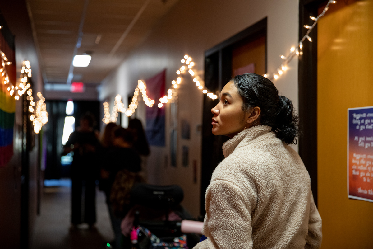 Student touring the Wall of Oppression at the Office of Multicultural Affairs
