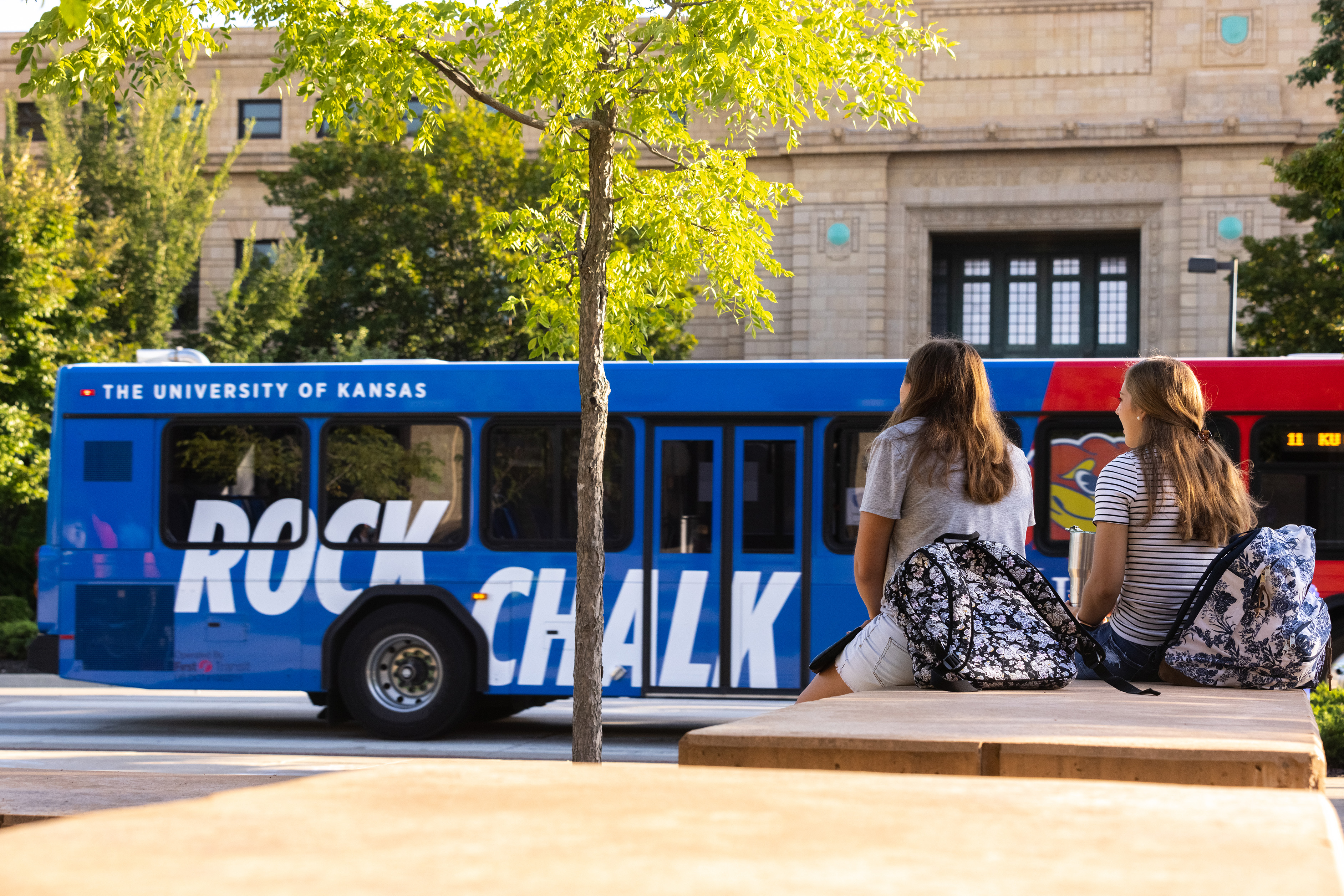 A campus bus passes students on campus for the first day of the fall semester.